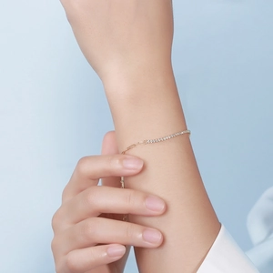 Elegant gold chain bracelet featuring inlaid 4A zircons on a model wrist for women