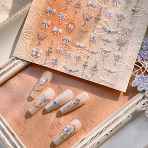 Retro gold 3D nail art stickers with blue butterflies and bows for elegant manicure