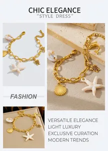 Detail of gold chain bracelet with sea star, turtle and dolphin ocean charms