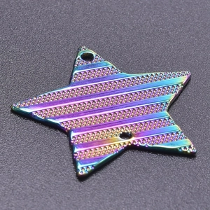 Macro shot of rainbow star pendant with horizontal texture and metallic finish