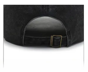 Detail view of adjustable metal buckle on black washed denim baseball cap back