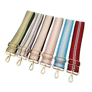 Adjustable woven shoulder straps with geometric patterns and golden metal buckles