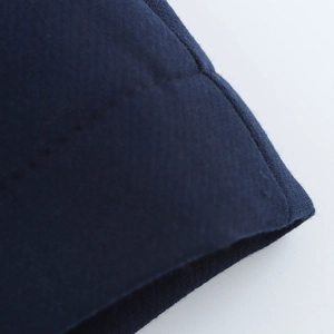Detailed close-up showing texture and sewing thread on dark blue A-line skirt fabric