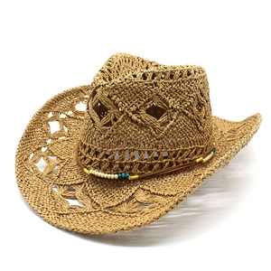 Detail of hollow woven straw cowboy hat with ethnic style colorful beads decoration