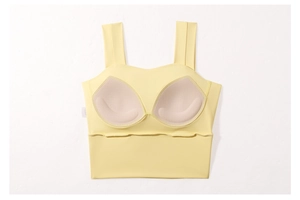 Close-up of breathable inner pads and wide straps on a yellow sports bra
