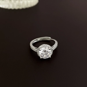 Detailed macro view of halo style ring with sparkling zircon and adjustable silver band