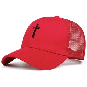 Close-up of red trucker hat featuring black cross embroidery and breathable mesh back