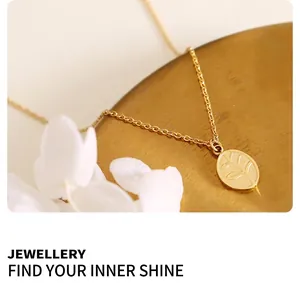 Detailed close-up of a gold oval pendant featuring intricate leaf vein relief texture