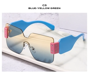 Detail of oversized square sunglasses featuring blue yellow green gradient lenses on marble