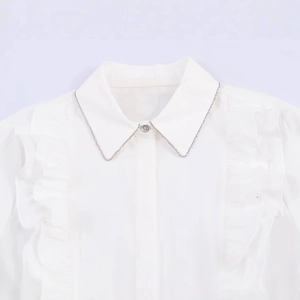 White poplin shirt with lapel collar featuring bead chains and ruffle detailing