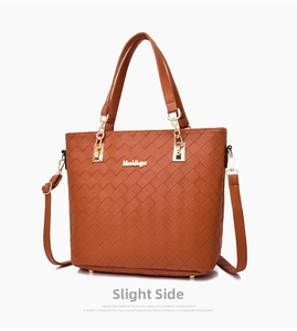 Detail of brown woven tote bag with gold metal hardware and adjustable shoulder strap