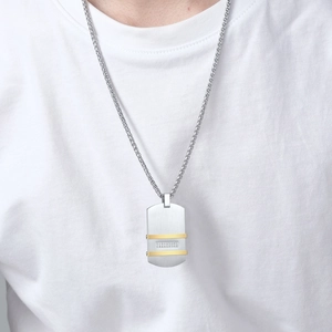 Close-up of men's stainless steel bicolor pendant with small rhinestones on woven chain