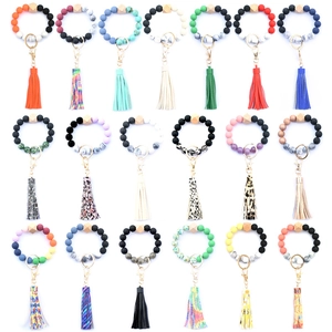 Detailed view of colorful silicone beaded wristlet keychains with tassels and leopard prints