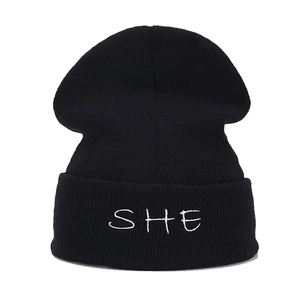 Classic black knitted beanie hat with white SHE embroidery for winter outdoor warmth