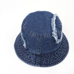 Close-up of dark blue distressed denim bucket hat with frayed edges and vintage worn details