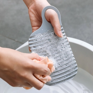 Portable gray hand-held washboard with wave texture for efficient laundry cleaning