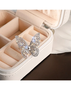 Macro detail of silver butterfly ring with sparkling crystals in premium jewelry box