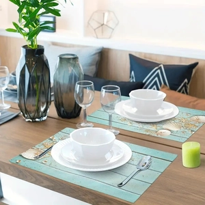 Detailed view of ocean themed placemats featuring starfish and shells on wood texture