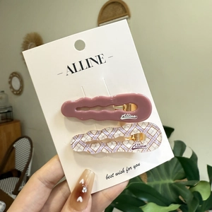Pink and purple checkered wavy hair clips set on branding card with gold metal clasp