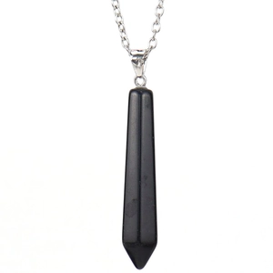 Macro shot of hexagonal black natural stone pendant with silver chain detail