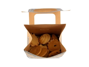 Macro view of Christmas kraft paper house candy box showing cookies inside and handle