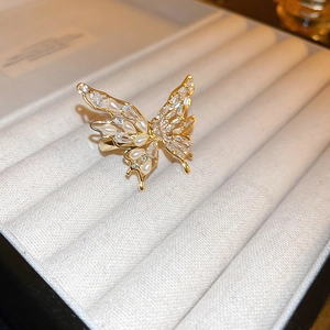 Macro detail of 18K gold plated bow ring with white pearls and sparkling zircons