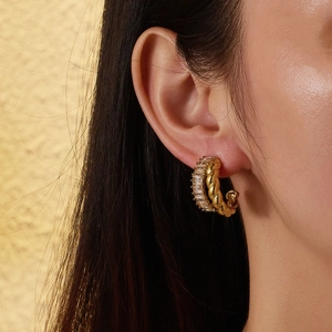 French retro gold twist earrings with double row baguette zircon stones on earlobe