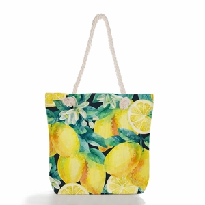 Detail of summer lemon print beach tote with durable white woven rope handles