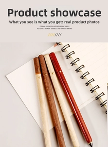 Detailed texture of four colors wood inkless everlasting pencils on a notebook