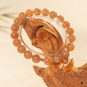 Detailed view of Sunstone bead bracelet featuring a gold horse charm and enamel accents
