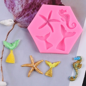 Pink silicone mold for mermaid tails and seahorse decorations with gold-painted finishes