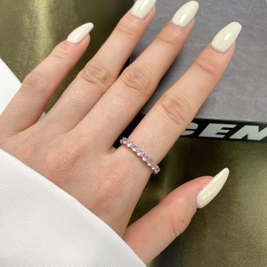 Close-up of a s925 silver eternity ring with pink round cut high carbon diamonds on hand