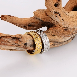 Square grid diamond checkered rings in gold and silver on natural wood branch