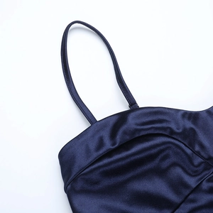 Detail of dark blue satin fabric showing silk texture and delicate shoulder strap
