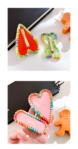 Detail of pink heart and oval hair clips with rainbow knit borders and Cute text