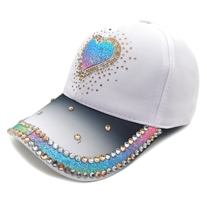 Detail of white baseball cap with colorful gradient heart and sparkling rhinestones