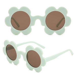 Detailed view of mint green flower-shaped sunglasses with brown lenses for party wear