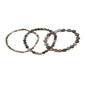 Vintage Chinese natural stone beaded bracelet set with golden heart pendant on white background