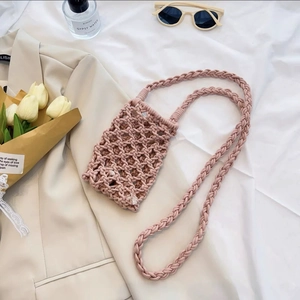 Detail of pink hand-woven cotton rope mini crossbody bag with a diamond mesh structure