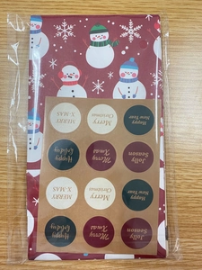 Detail of Christmas gift bags set with snowman patterns and round kraft seal stickers