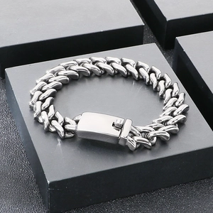 Detail of 15mm stainless steel Cuban chain bracelet on black display box with folding clasp