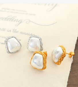 Close-up of elegant irregular square pearl earrings in gold and silver titanium steel