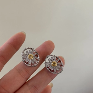 Silver-toned daisy flower earrings with cubic zirconia petals and yellow stone center