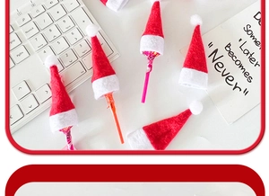 Close-up of mini red felt Christmas hats for lollipop decoration on a white background
