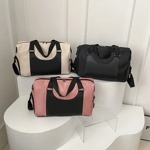Three multi-color fitness duffel bags with waterproof fabric on a white display stand