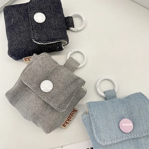 Three-color denim earphone cases in blue and grey with flip buttons and snap hooks