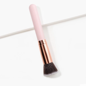 Professional pink flat top foundation brush with dense gradient bristles and gold ferrule