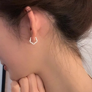 Elegant S925 sterling silver hollow flower ear cuff shown on a model for a minimalist look