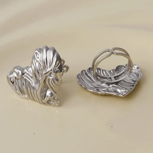 Detail of silver lion head ring featuring adjustable open band and intricate carving