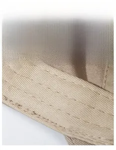 Close-up of widened sweatband on beige cotton baseball cap with neat stitching